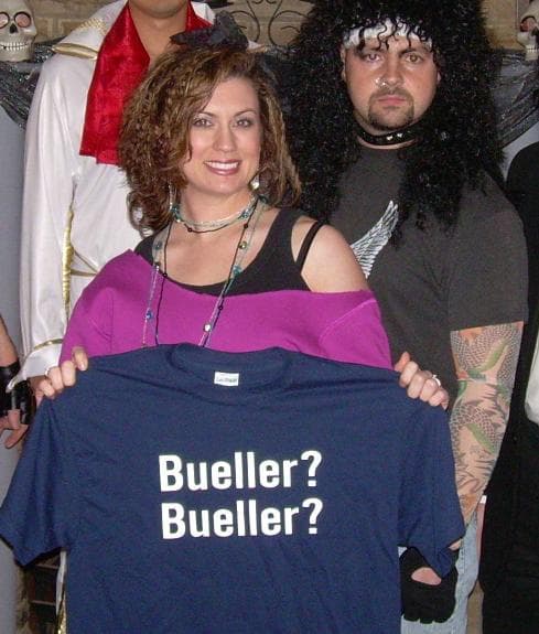 A Bueller fan holding a Bueller T-shirt with band members