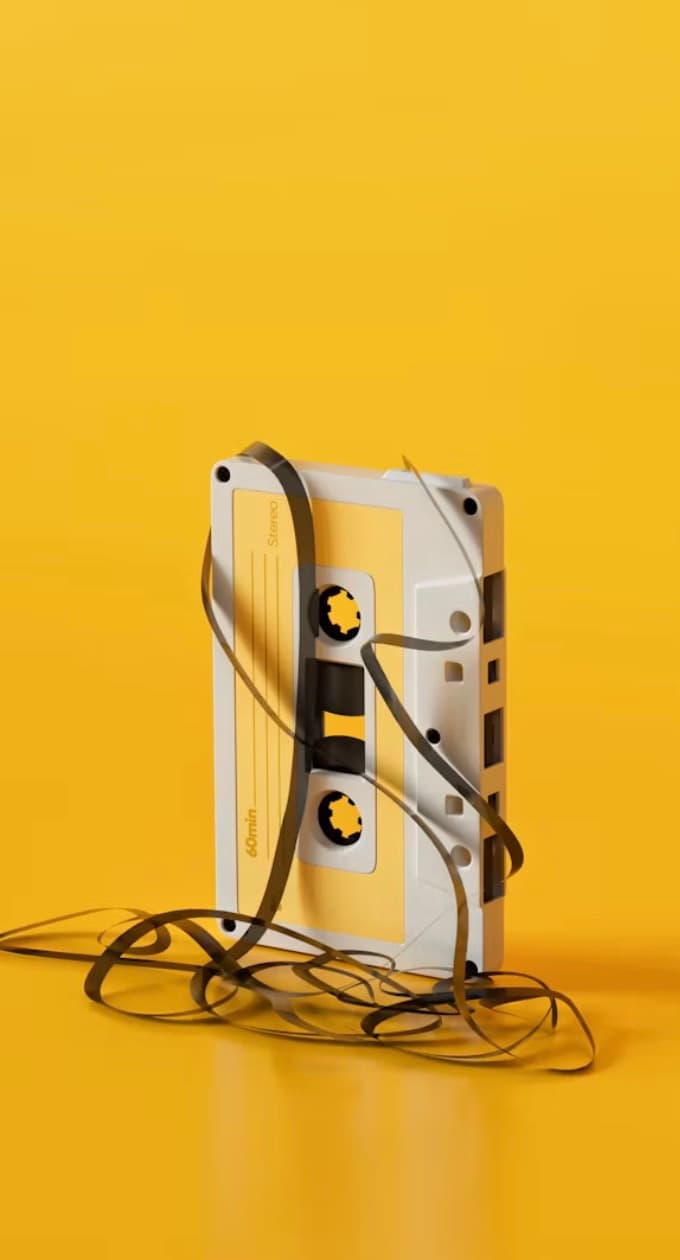A yellow cassette with loose tape